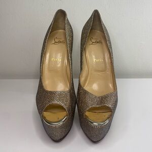 Gold Christian Louboutin 6” shoes.